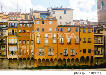 Old yellow buildings hang over the river Old yellow buildings hang over the river 24099412