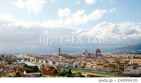 Florence looks gorgeous while white clouds fly over it in a sunn 24099430