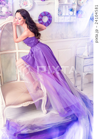Woman posing in long purple dress 24104581
