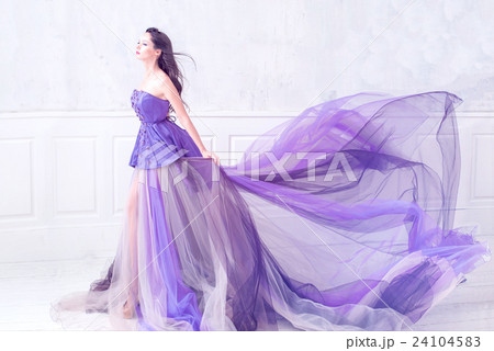 Woman posing in long purple dress Woman posing in long purple dress 24104583