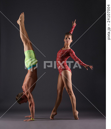 Studio photo of sports gymnasts posing at camera Studio photo of sports gymnasts posing at camera 24107004