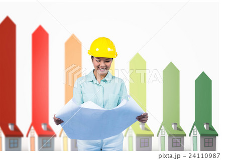 Composite image of architect reading a plan with yellow helmet 24110987