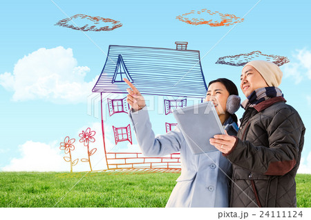 Composite image of couple looking away while holding digital tablet 24111124