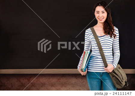 Composite image of cheerful woman with shoulder bag and files 24111147