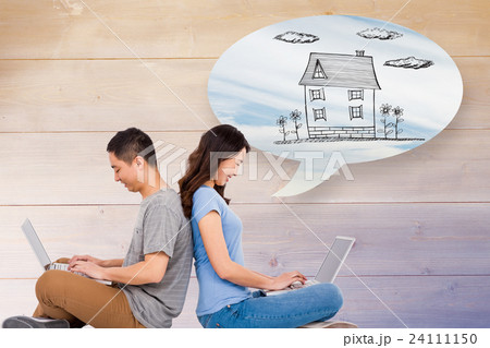 Composite image of happy young couple using laptop while sitting back to back 24111150