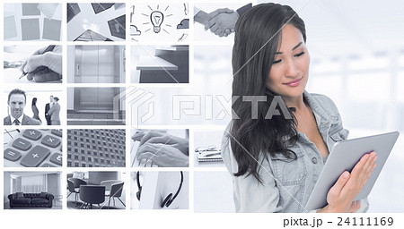 Composite image of asian woman holding tablet Composite image of asian woman holding tablet 24111169