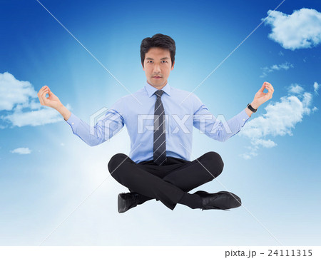 Composite image of asian businessman doing yoga 24111315