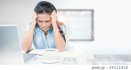 Composite image of stressed businesswoman working at her desk 24111418