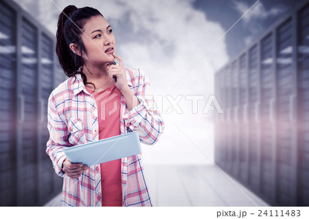Composite image of thoughtful woman with finger on chin holding tablet 24111483