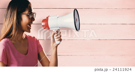 Composite image of asian woman shouting in megaphone Composite image of asian woman shouting in megaphone 24111924
