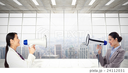 Composite image of portrait of a businesswoman shouting through a megaphone 24112031