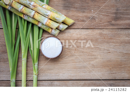 Top view white sugar and sugar cane and leaf on wooden 24115282