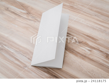 Trifold white template paper on wood texture . 24118175