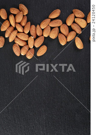 roasted almonds on slate background 24120450
