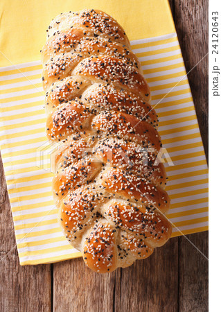 Freshly baked loaf of braided, with sesame seeds 24120643