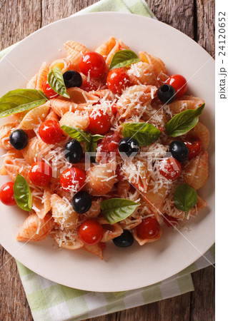 Conchiglie pasta with tomatoes olives and parmesan 24120652