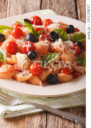 Conchiglie with tomatoes, olives and parmesan 24120657