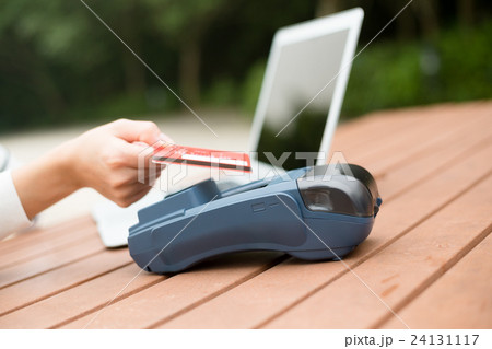 Woman using credit card to pay Woman using credit card to pay 24131117