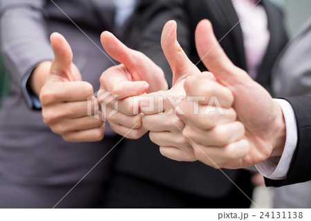 Business partners keeping thumbs up 24131138