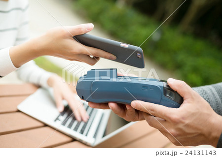 Customer paying with NFC technology Customer paying with NFC technology 24131143