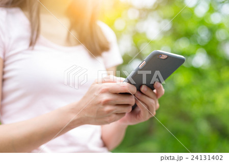 Woman use of mobile phone over green background Woman use of mobile phone over green background 24131402