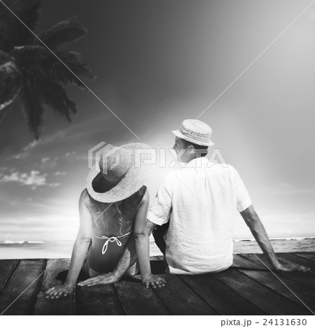 Couple Sitting on Wooden Floor at Beach Concept 24131630