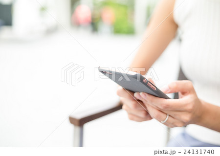 Woman using cellphone for text message Woman using cellphone for text message 24131740