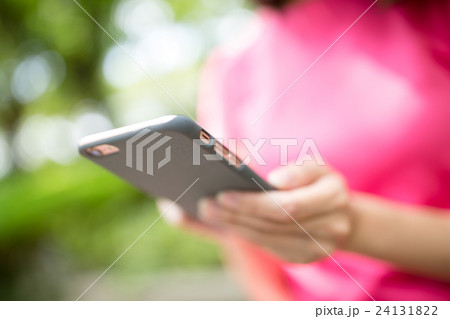 Woman use of phone in park 24131822
