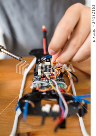 Man welding parts on drone body 24132163