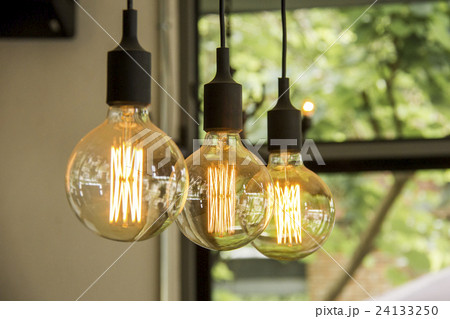 Glowing retro light bulbs hanging from ceiling 24133250