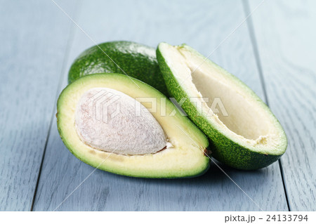 ripe green avocado on blue wood table ripe green avocado on blue wood table 24133794
