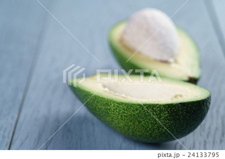 ripe green avocado on blue wood table ripe green avocado on blue wood table 24133795