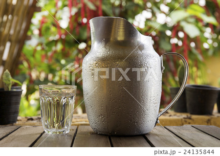 A Glass and Metal Jug of water 24135844