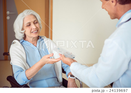 Doctor giving pills his patient Doctor giving pills his patient 24139697