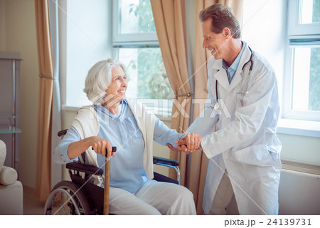 Nice doctor supporting senior woman 24139731