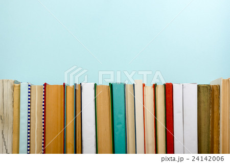 Books on grunge wooden table desk shelf in library 24142006