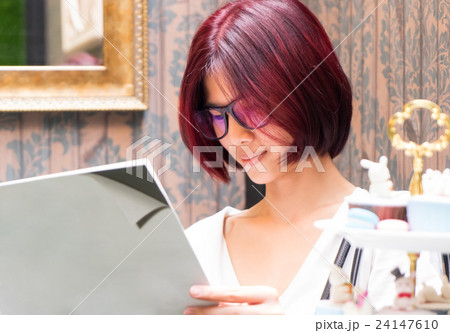 Nerdy girl is reading a blank book cover 24147610