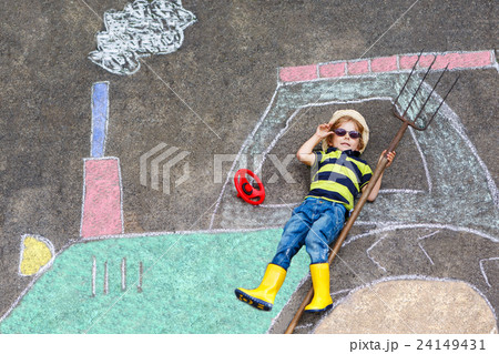 Little boy having fun with tractor picture drawing 24149431