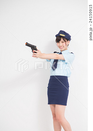 おもちゃのピストルを持った婦人警官のコスプレをした女性 24150915