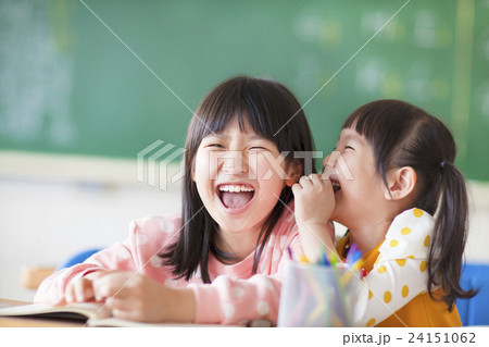 Laughing little girls sharing secrets in class 24151062