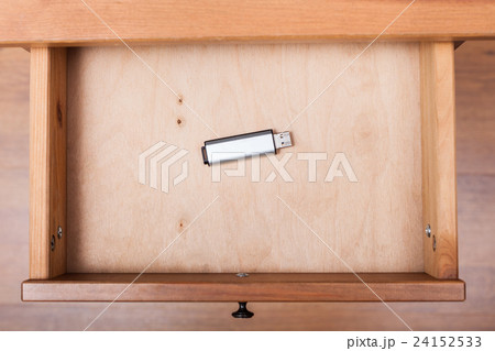 flash drive in open drawer of nightstand flash drive in open drawer of nightstand 24152533