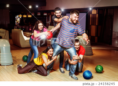 Friends having fun in bowling 24156245