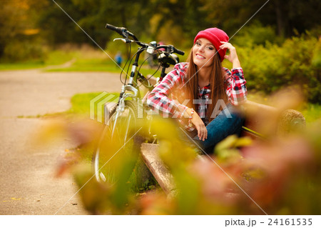 girl relaxing in autumnal park with bicycle. girl relaxing in autumnal park with bicycle. 24161535
