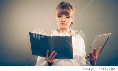 Woman learning with ebook and book. Education. 24162202