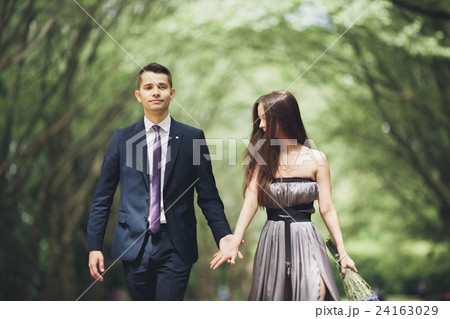Handsome young couple posing outdoors after Handsome young couple posing outdoors after 24163029
