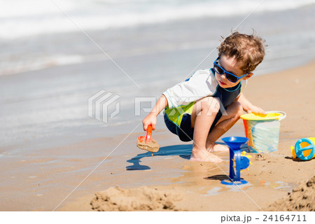 Boy playing on the beach Boy playing on the beach 24164711