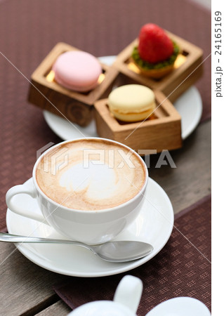 Cup of cappuccino and macaroons 24165169