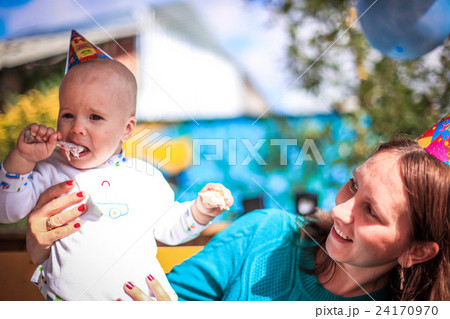 Mom and baby celebrate birthday in sunny day at 24170970