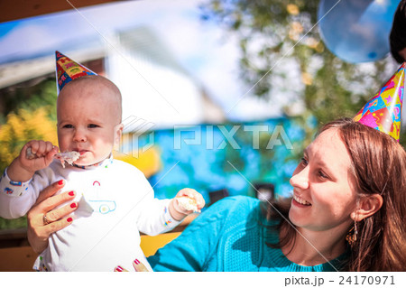 Mom and baby celebrate birthday in sunny day at Mom and baby celebrate birthday in sunny day at 24170971