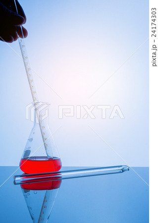 Lab glassware on glass table in warm tone. 24174303